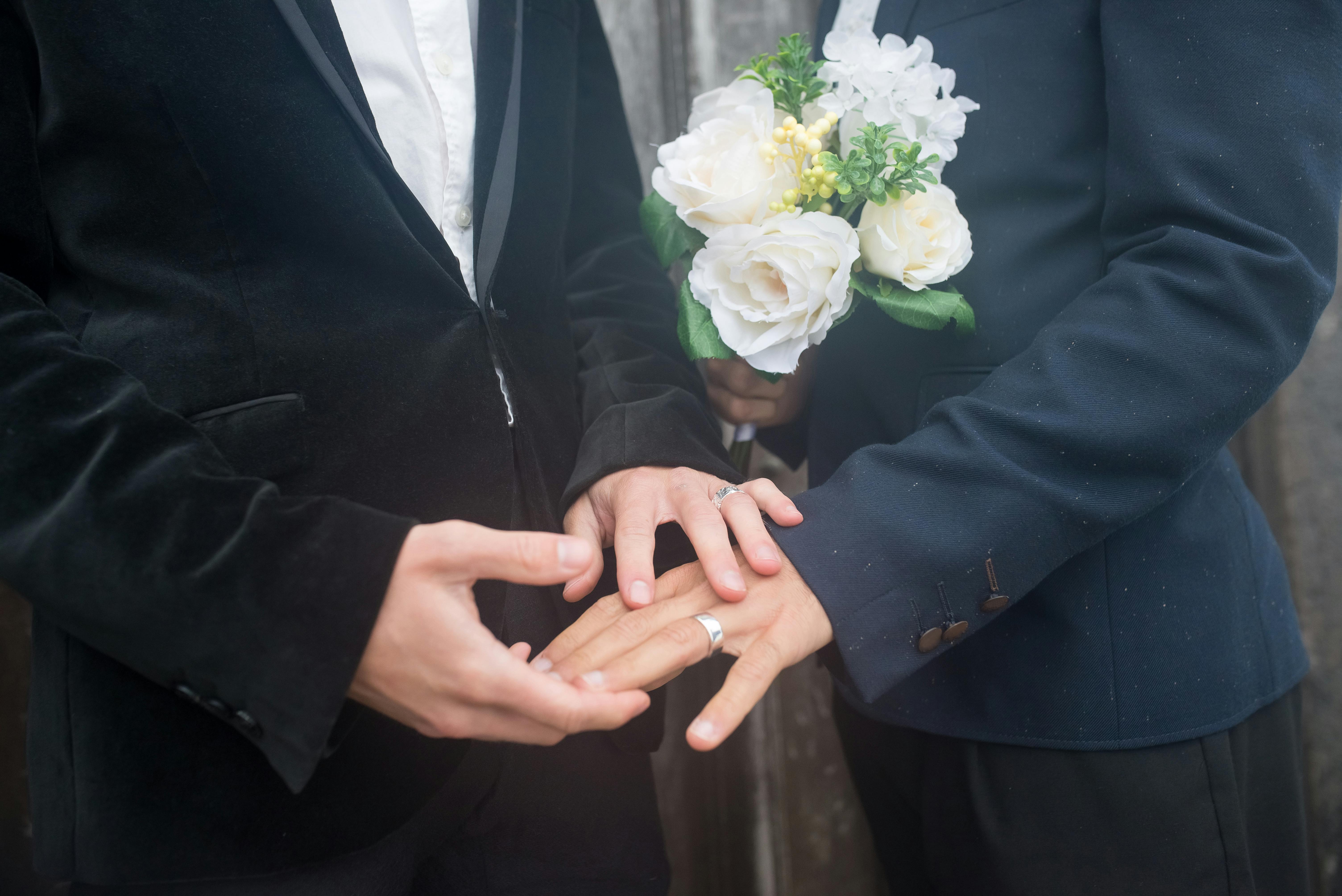 Close up of wedding rings and white flowers during a ceremony